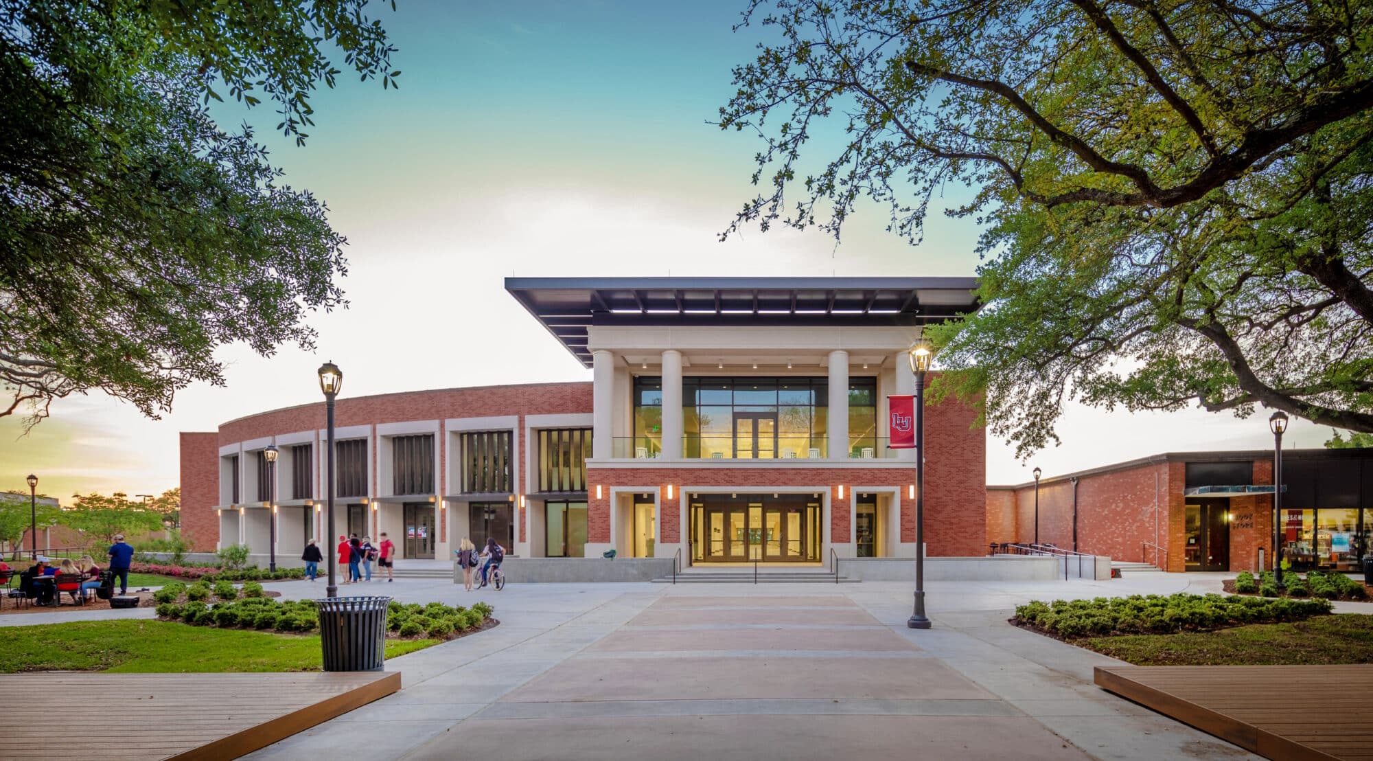 Modern university building entrance with students.