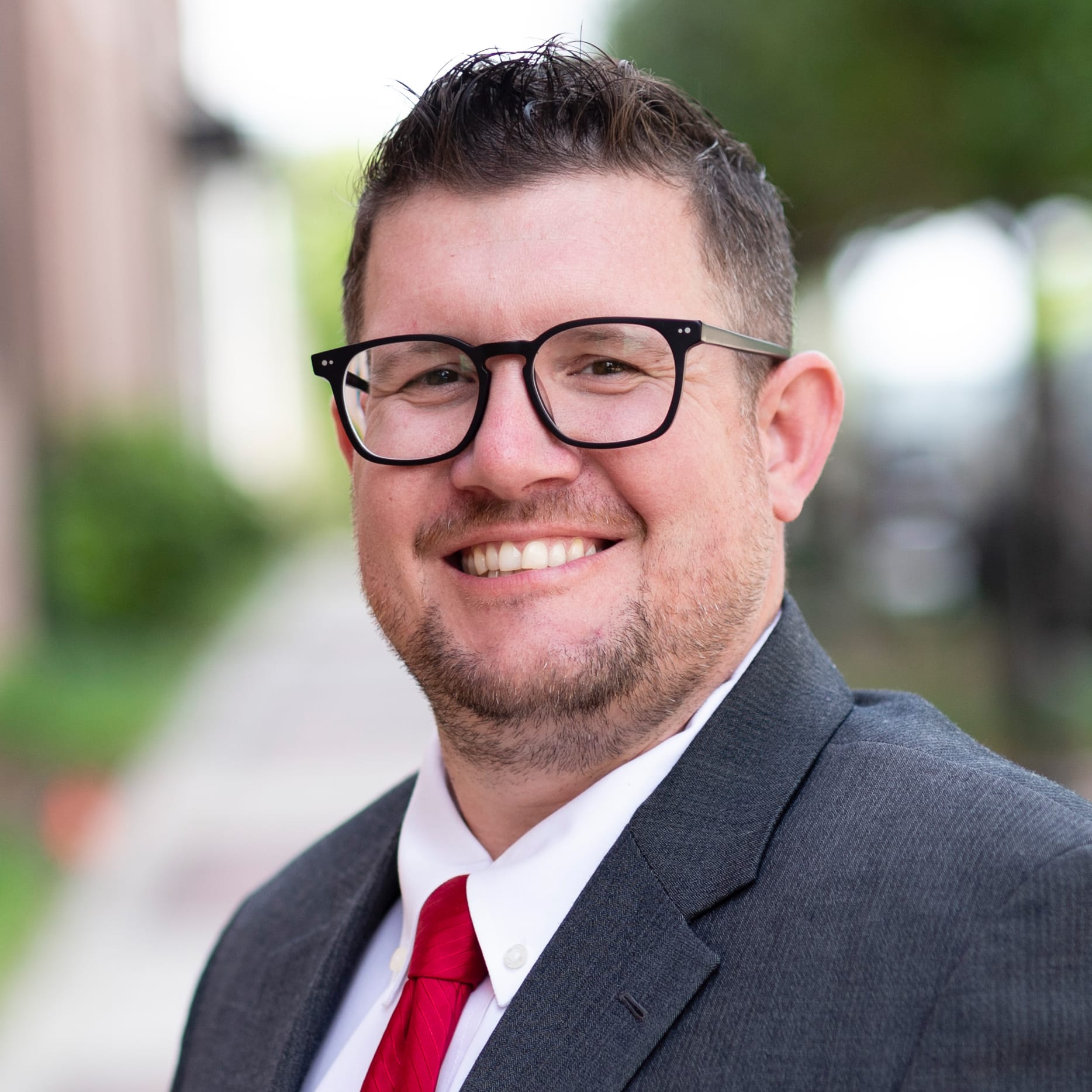 Smiling businessman in suit outdoors