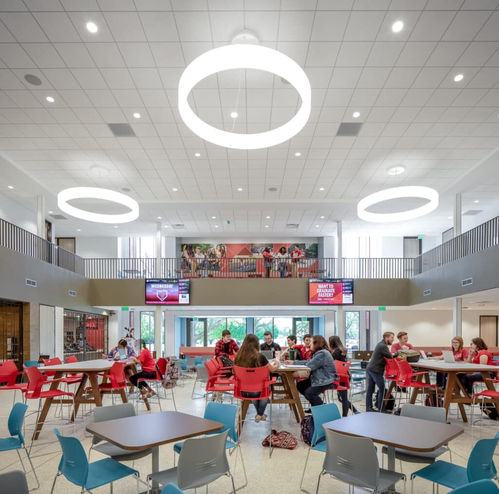 Modern school cafeteria with students dining.