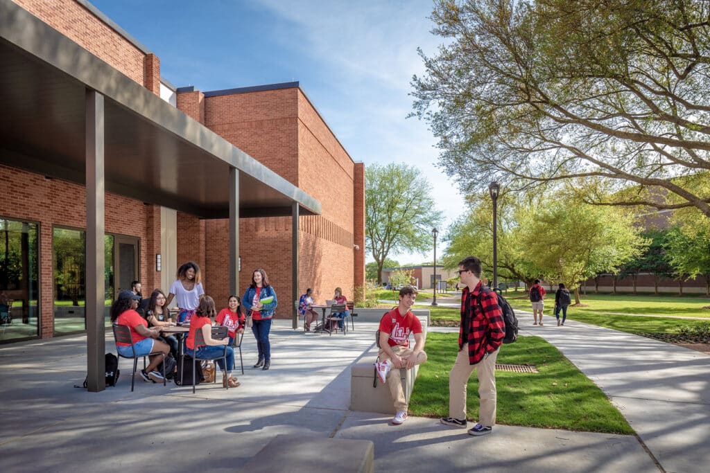 Students socializing outside campus building.