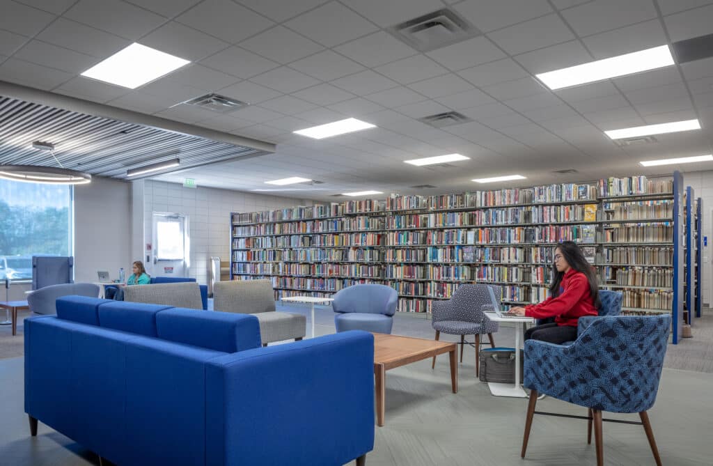 Modern library interior with students reading.