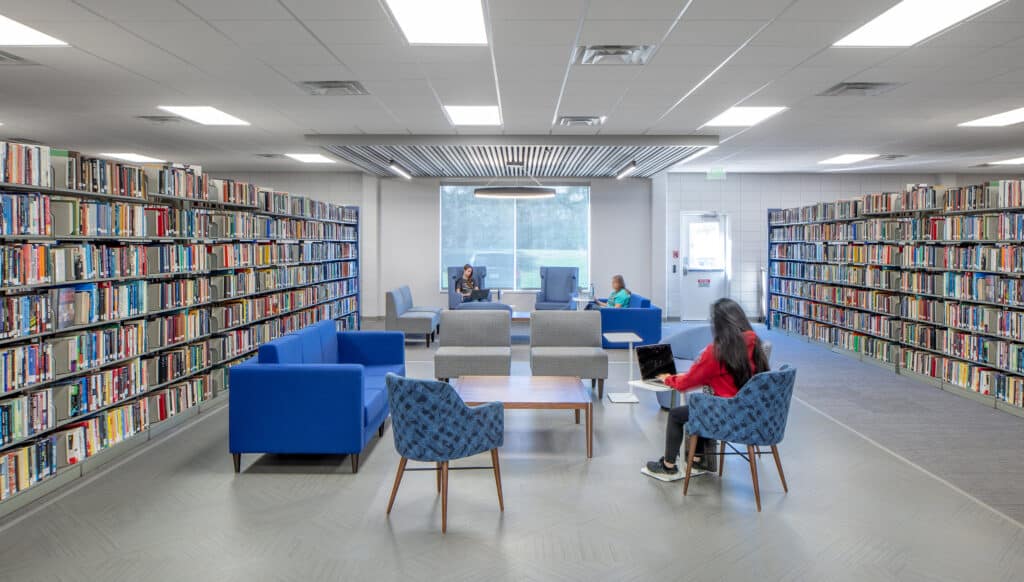 Modern library interior with students reading.