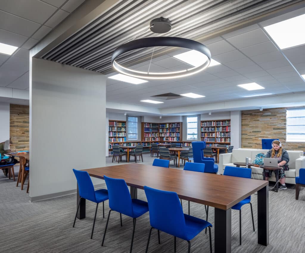 Modern library interior with students and circular lighting
