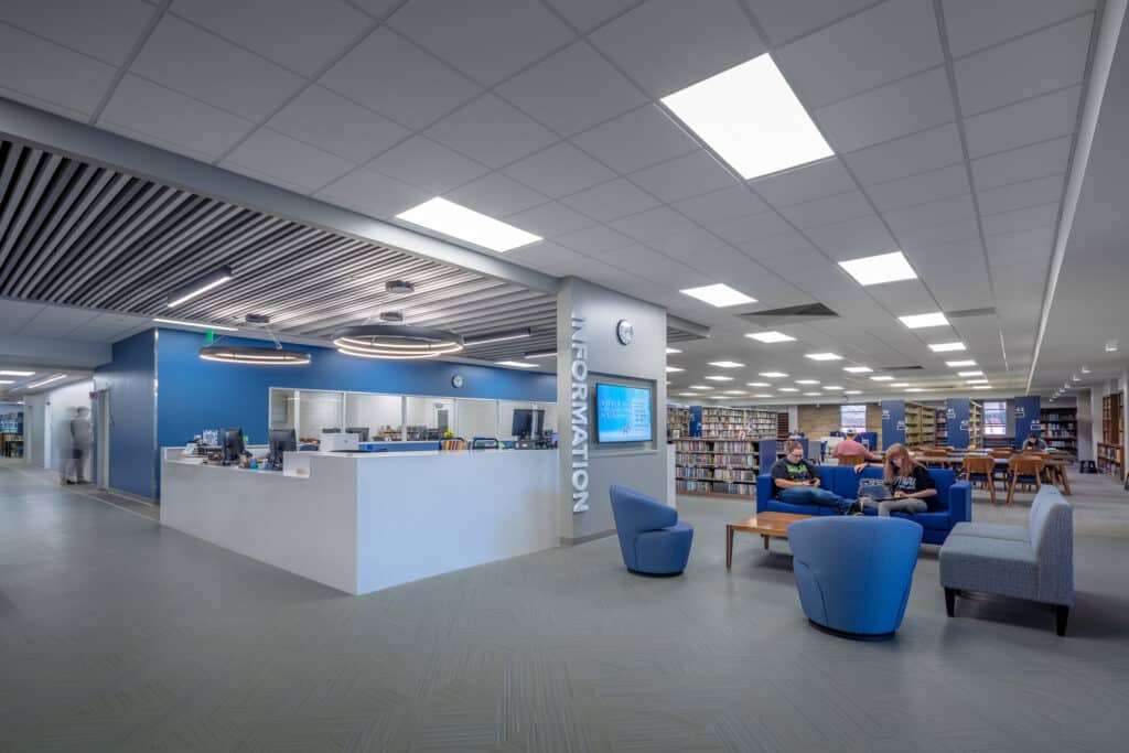 Modern library interior with patrons reading.