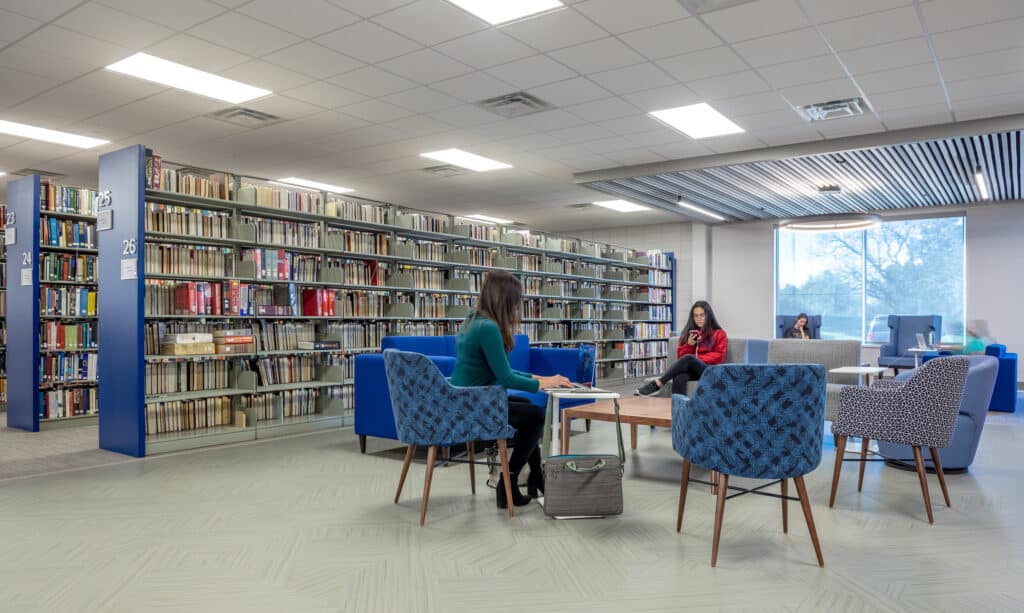 People studying in modern library interior.