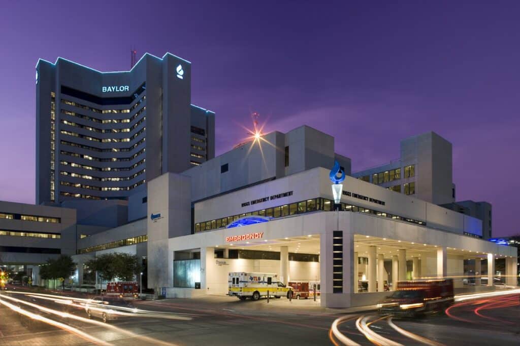 Baylor hospital building exterior at twilight with light trails.