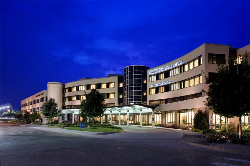 Modern hospital building exterior at twilight.