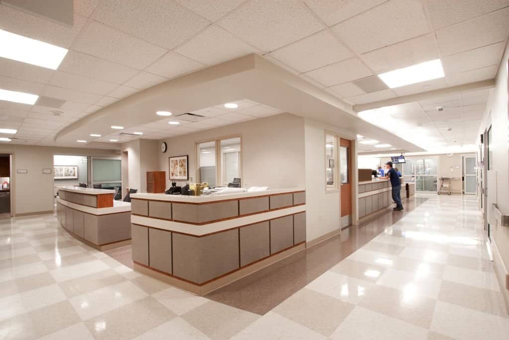 Modern hospital reception area with staff.