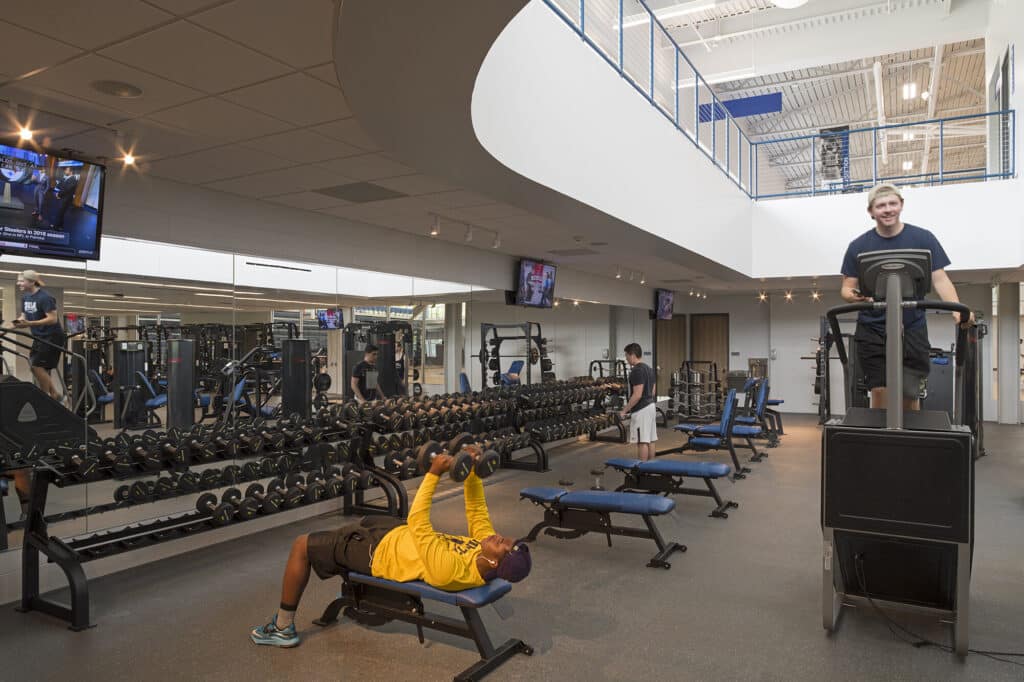 Modern gym interior with exercising people