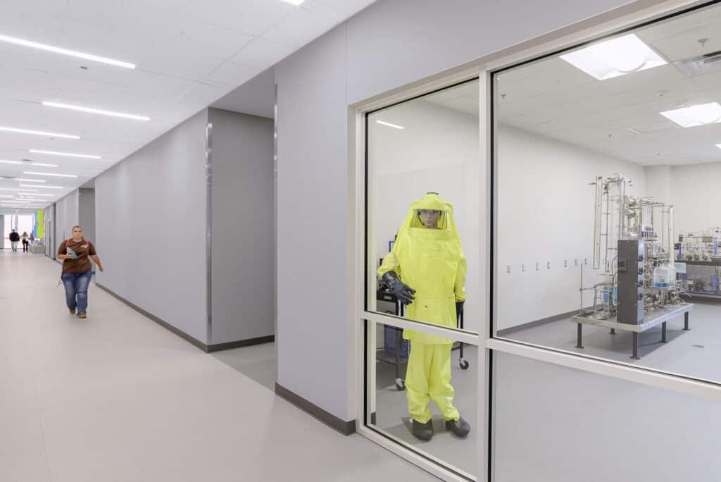 Person in hazmat suit inside laboratory.