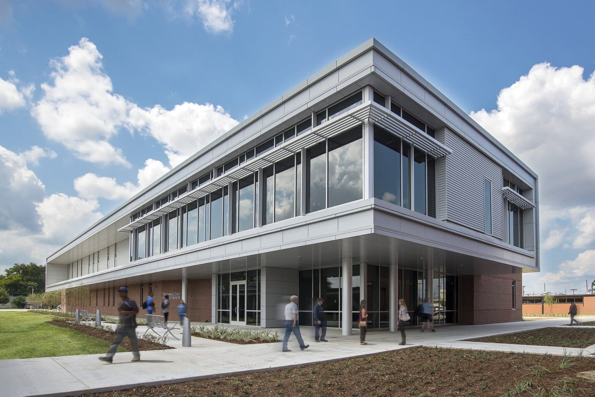 Modern office building with people walking outside.