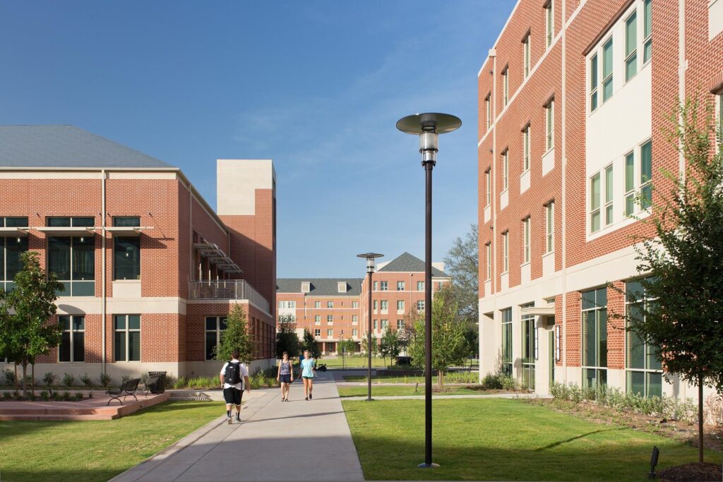 Campus pathway with students and modern buildings.