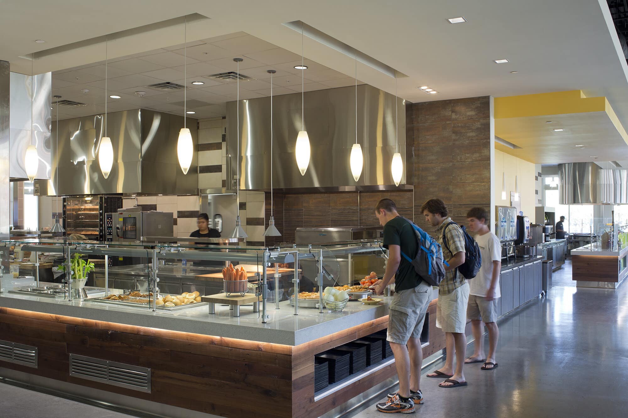Modern cafeteria interior with customers choosing food.