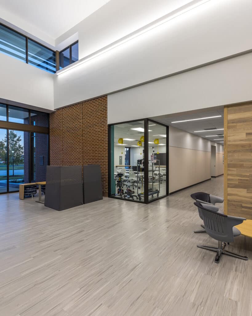 Modern office interior with glass walls and scientific lab.