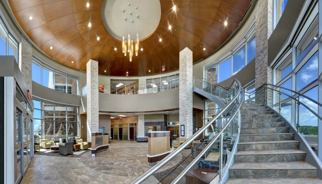 Modern lobby interior with staircase and chandelier.