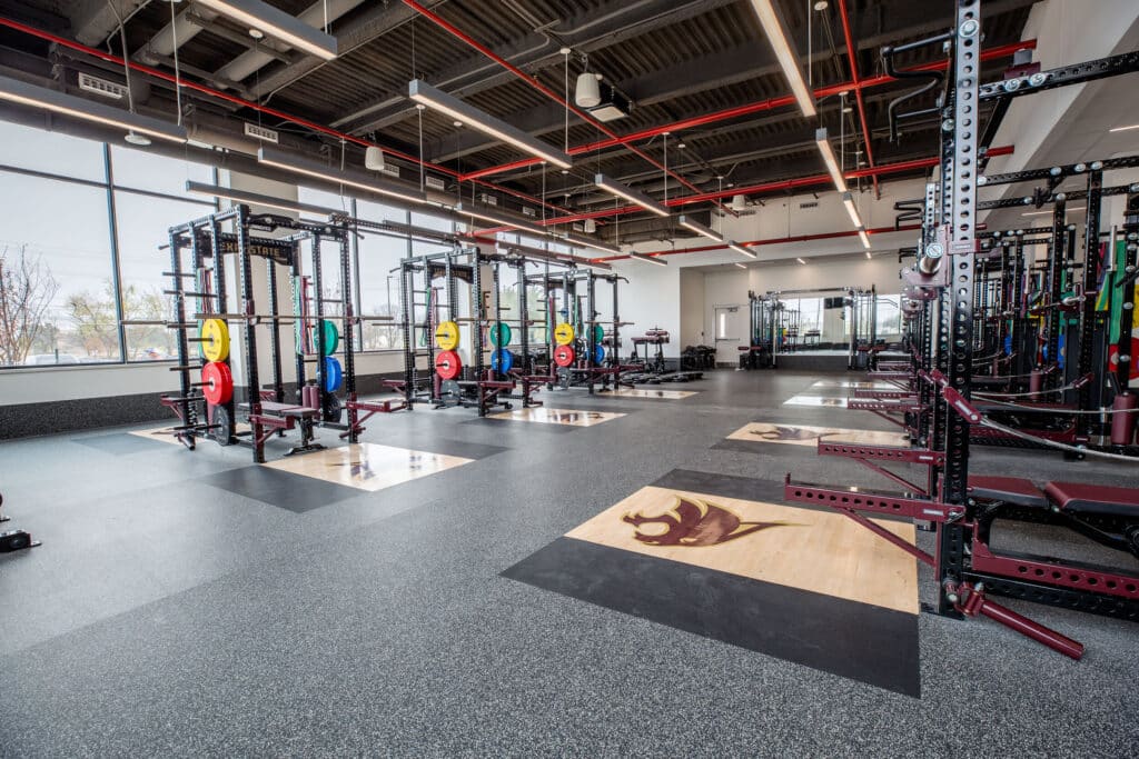 Modern gym with equipment and large windows