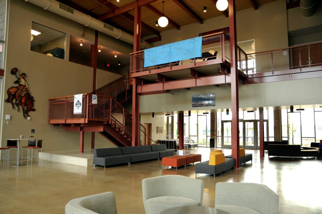 Modern lobby with red staircase and seating area.