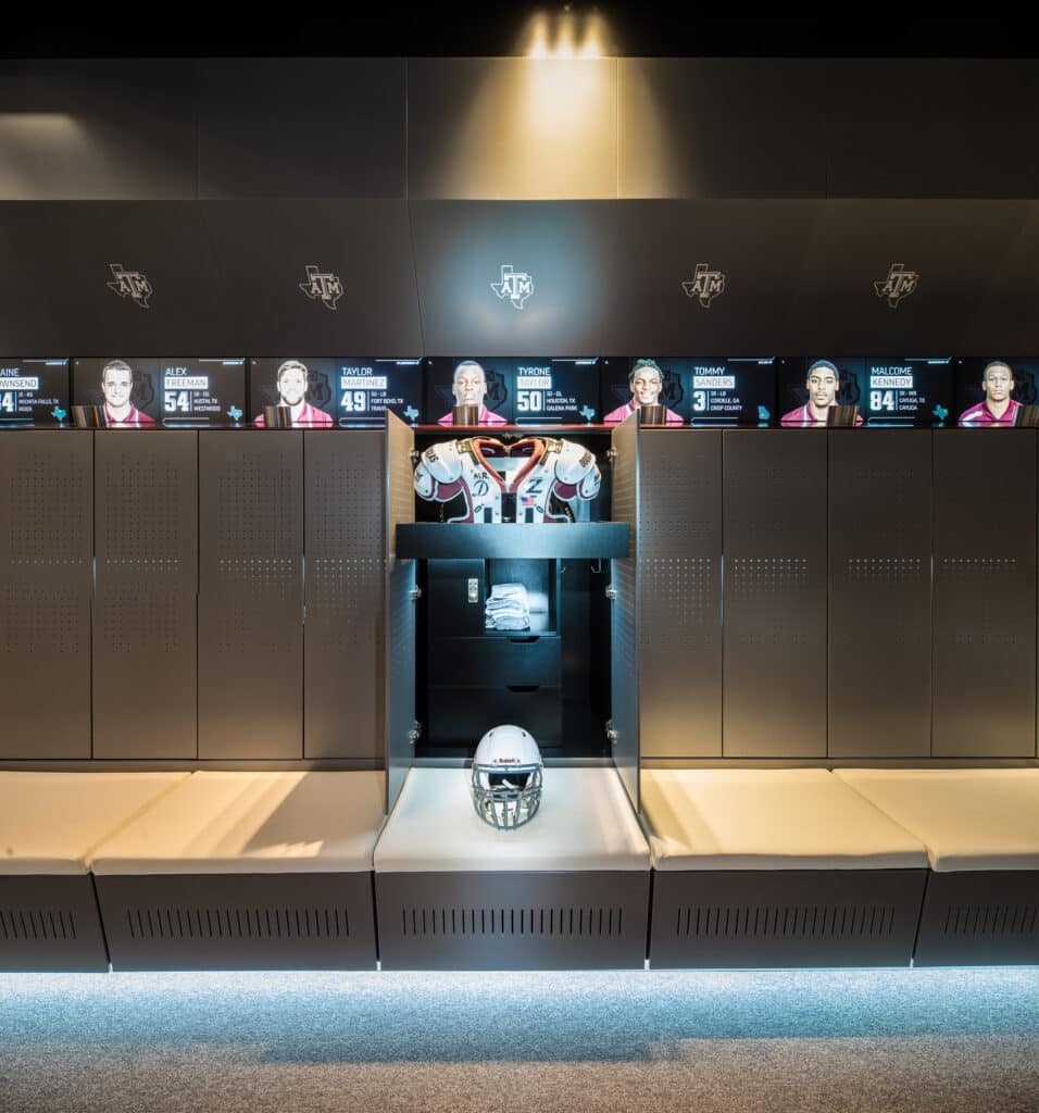 Modern football locker room with equipment and jerseys.