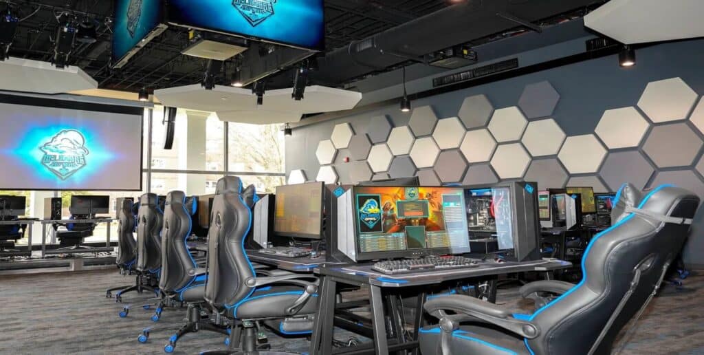 Modern esports gaming arena with computers and chairs.
