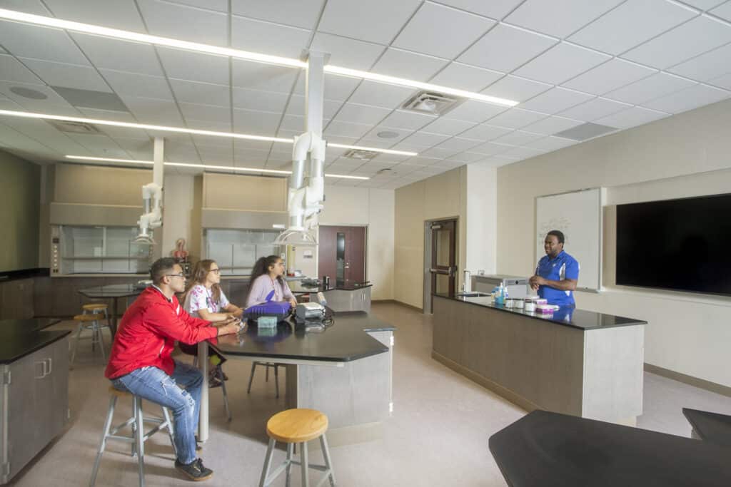 Students watching demonstration in modern laboratory classroom.