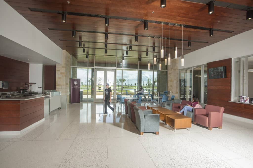 Modern lobby interior with people and furniture.