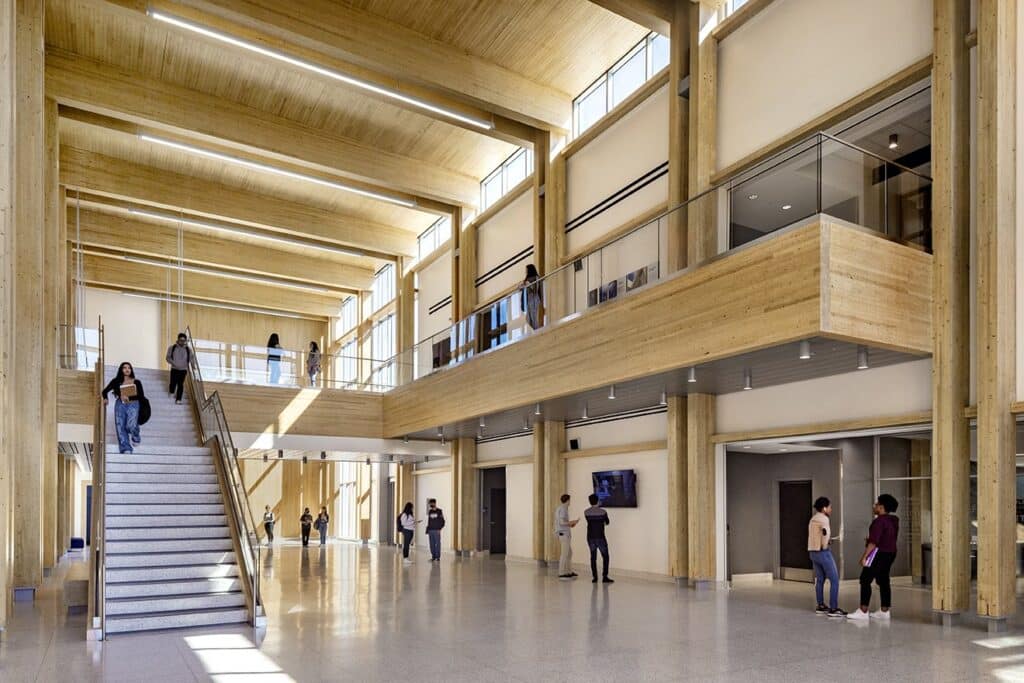 Modern university atrium with students and wooden architecture.
