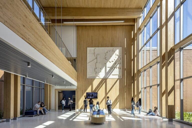 Modern college atrium with students and natural light.