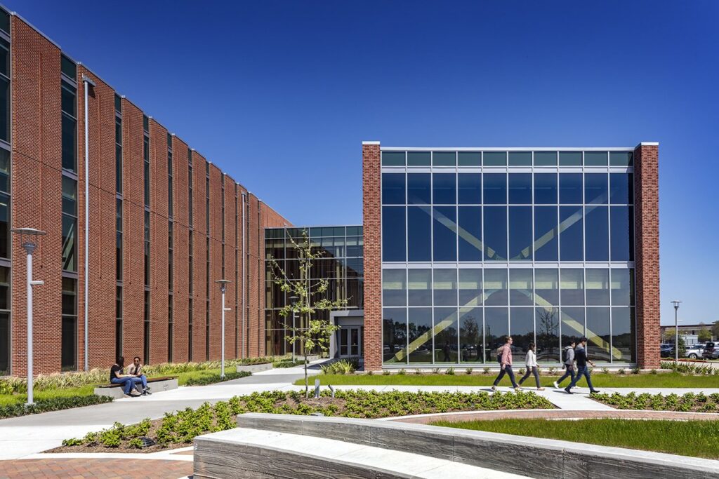 Modern university building with students walking outside.