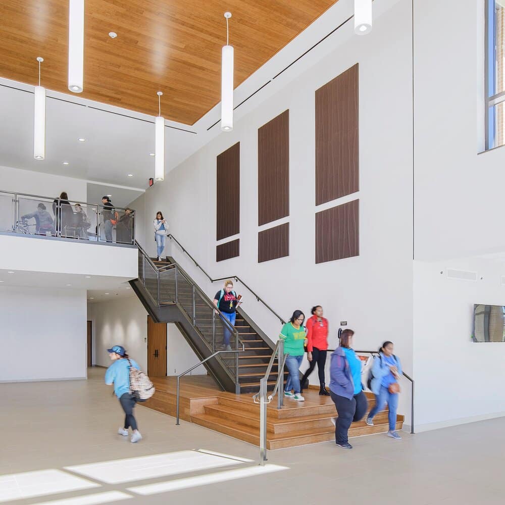 Modern building interior with people using stairs.