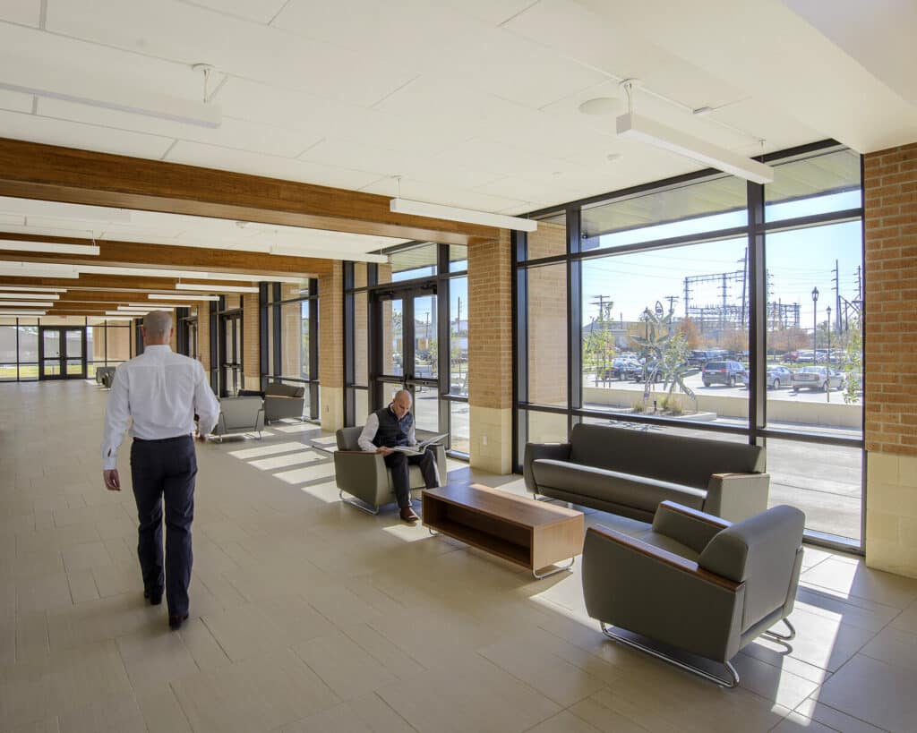 Modern lobby interior with natural lighting and people.