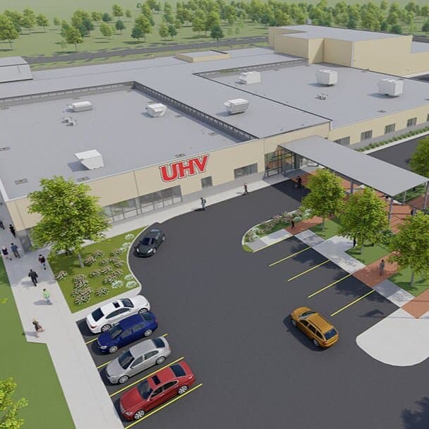 3D rendering of UHV campus building with parking lot.
