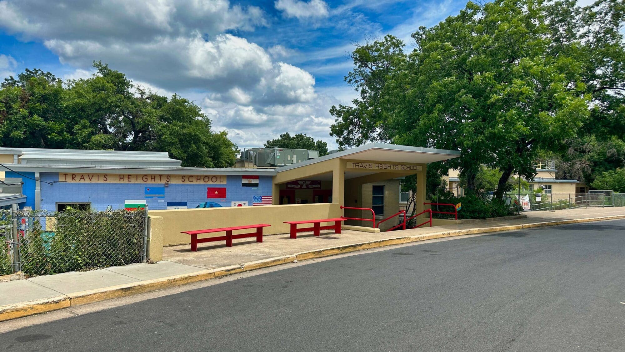 Travis Heights Elementary School facade with red benches.