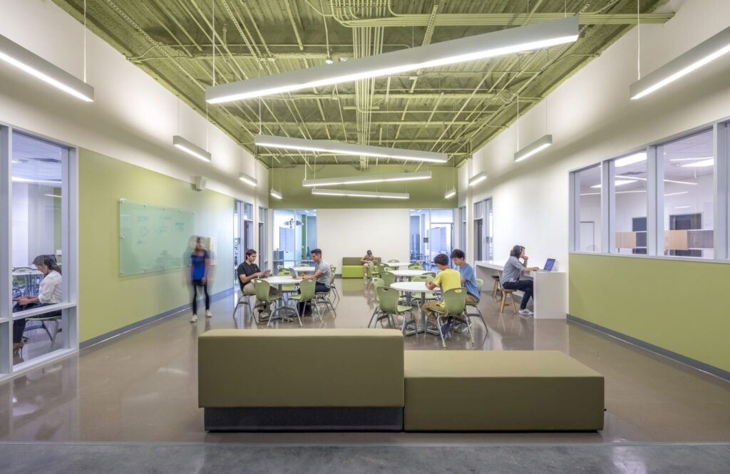 Modern office breakout area with employees working.