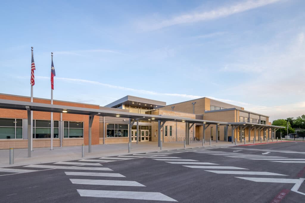 Modern elementary school building facade at twilight.