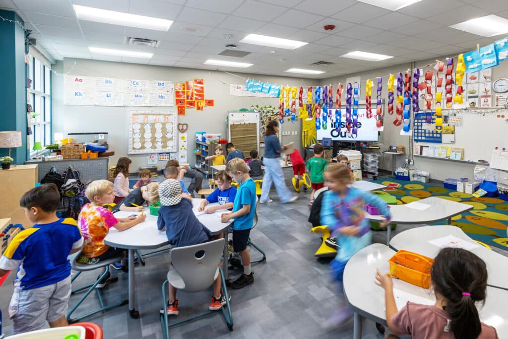 Children engaging in activities in a colorful classroom.