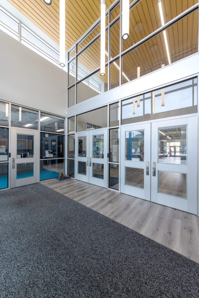 Modern office lobby interior with glass doors.