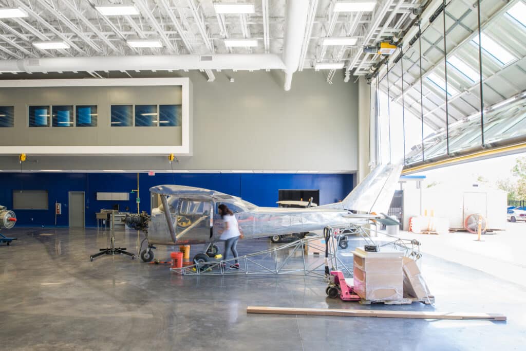 Aircraft hangar with plane undergoing maintenance