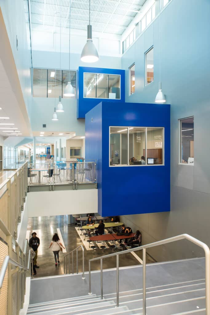 Modern office interior with blue accents and communal area.
