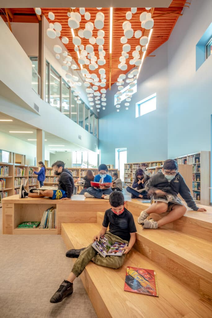 Modern library interior with students reading.