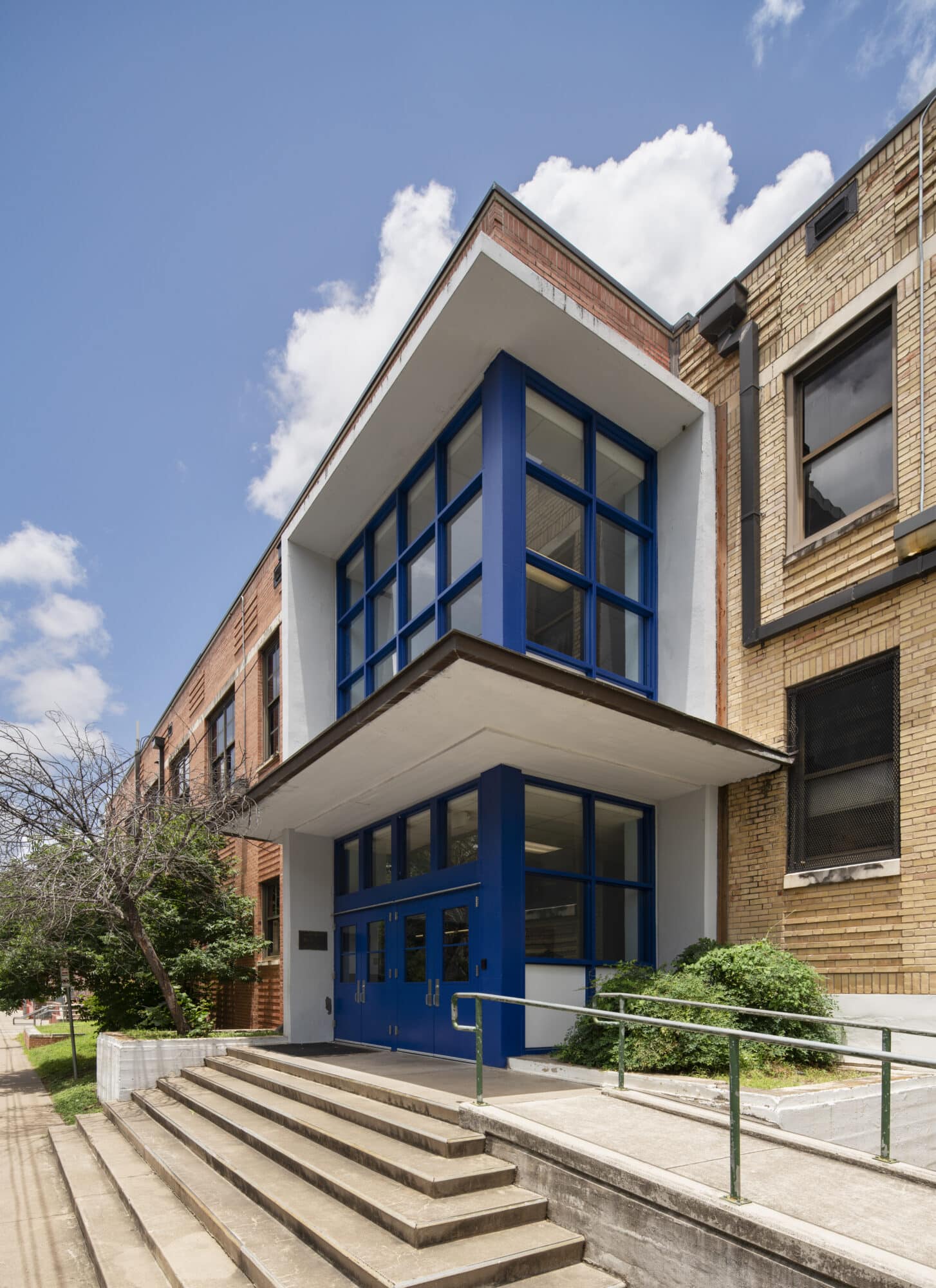 Modern blue entrance of urban school building.