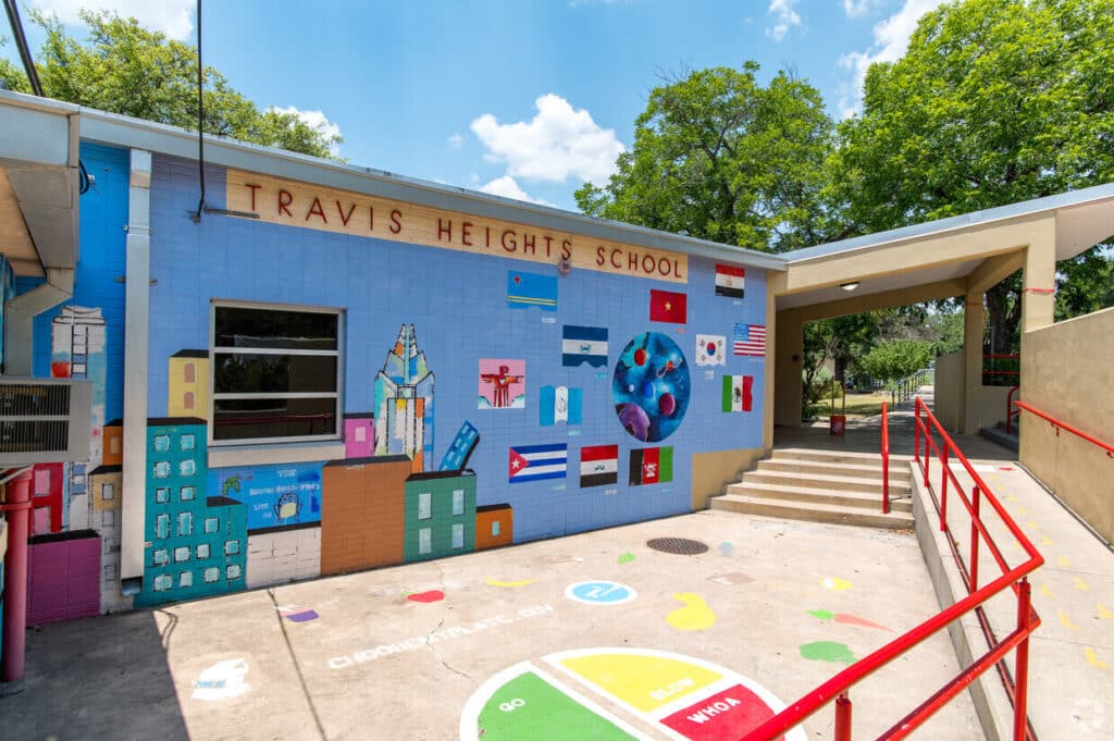 Colorful mural at Travis Heights School entrance.