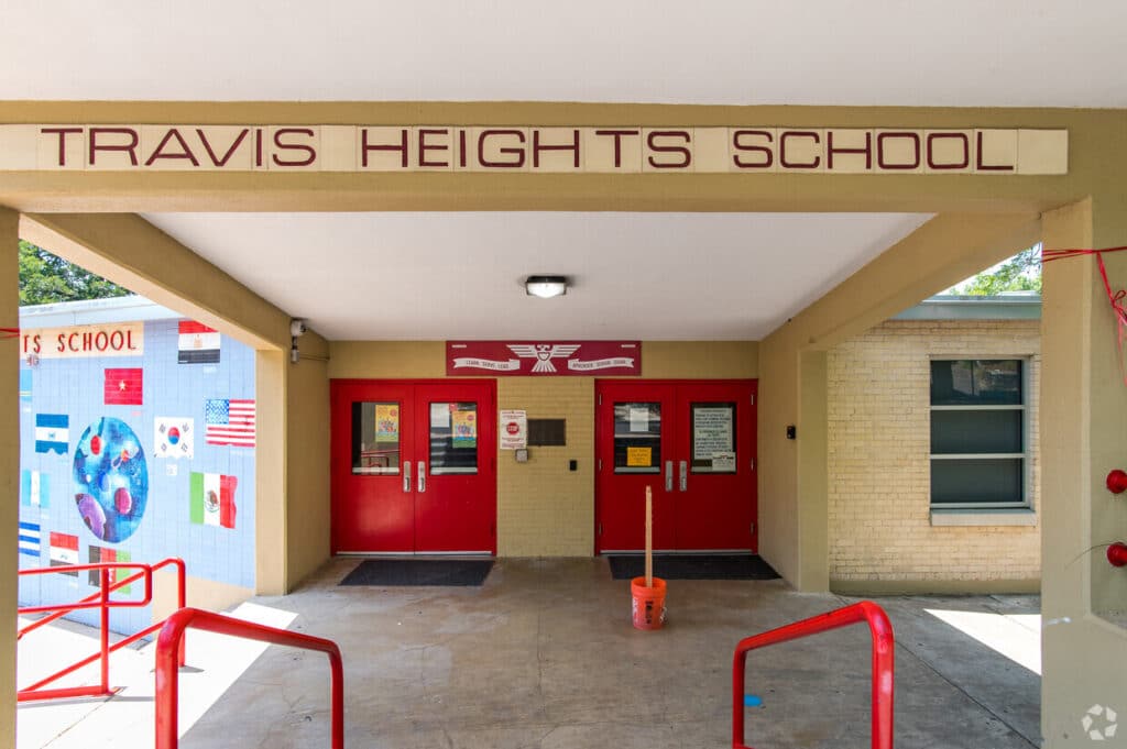 Entrance of Travis Heights School with red doors.